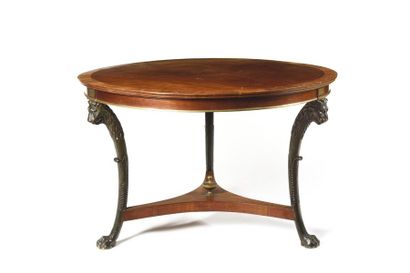 null Round pedestal table in mahogany veneer and patinated wood, ornamented with...