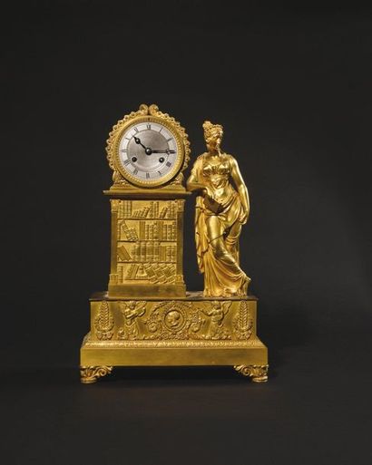 null Gilded bronze clock, the pewter dial with Roman numerals for the hours supported...