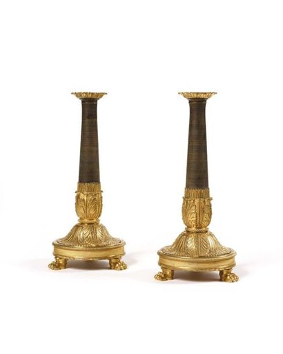null Pair of gilt bronze candleholders decorated with large palmettes, shaft in dark...