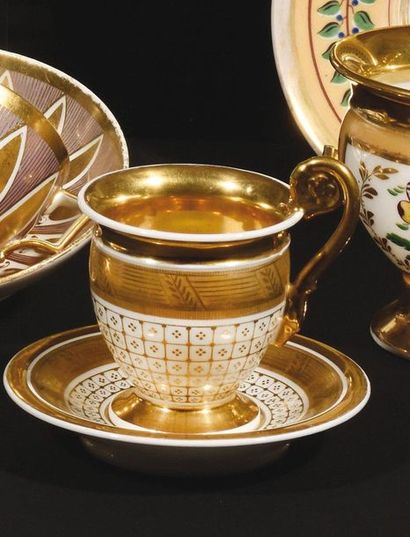 null Paris Two high-handled cups and their saucer in porcelain, one with polychrome...