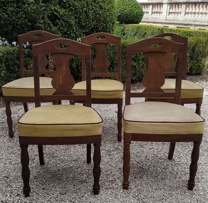 null A suite of FIVE mahogany chairs with flat openwork back and stylized decoration...