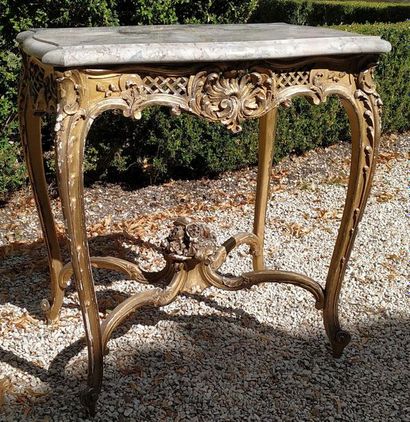 null MODERN TABLE in gilded wood molded and carved with foliage and scrolls, the...