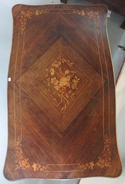 null A Louis XV style middle table in marquetry, with an animated top, opening by...