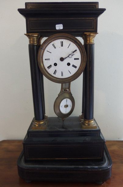 null A Napoleon III portico clock in blackened wood on a base, enamelled dial.

Missing...