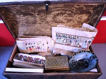 null A large antique trunk lined with studded leather containing souvenirs from travels...