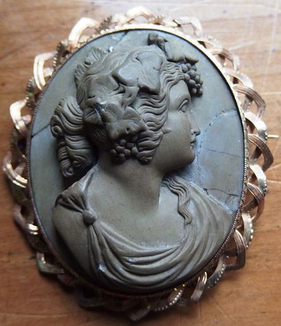 null A terracotta cameo representing a bacchante, mounted as a pin.

18K gold frame,...