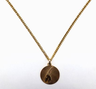 null NECKLACE in 18 K yellow gold holding a medal decorated with a Capricorn. French...