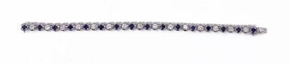 null A supple 18K white gold BRACELET adorned with an alternation of sixteen sapphires...