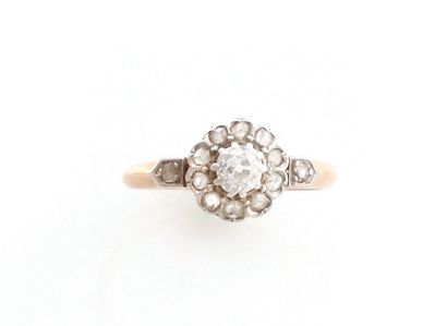 null RING in 18K pink gold and platinum holding an old cut diamond in its center...