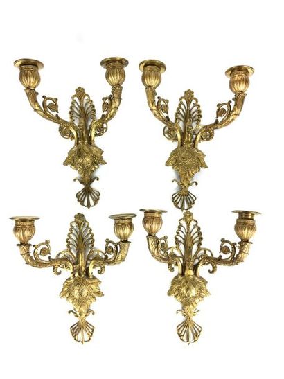 null Suite of FOUR Sconces in chased and gilt bronze with two moving light arms joined...