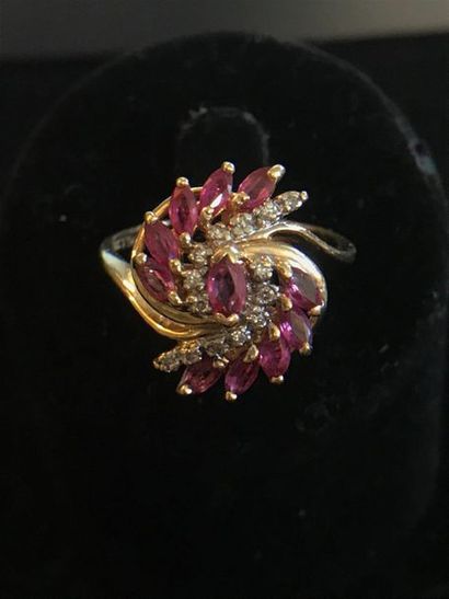 null RING in 14k yellow gold adorned with rubies and diamonds in a coiled movement....