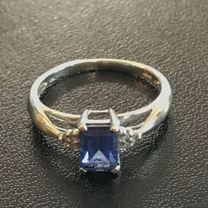 null RING in 10k white gold adorned with a sapphire flanked by small diamonds.

TDD:...