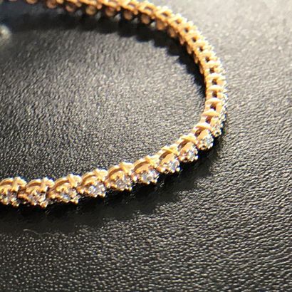 null Fine 14k yellow gold bracelet decorated with small diamonds all around, safety...