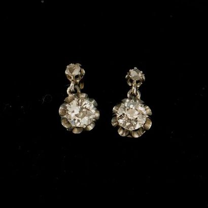 null EARRINGS 

in 18K white and yellow gold retaining a brilliant cut diamond of...
