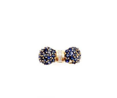 null 18k yellow gold ring representing a knot with a paving of sapphires and calibrated...