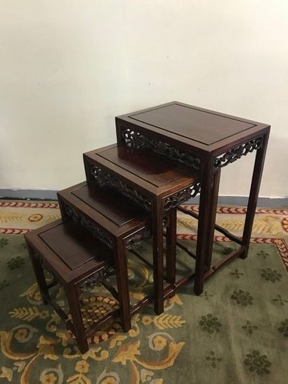 null Set of four Chinese nesting tables in carved wood with openwork decoration....