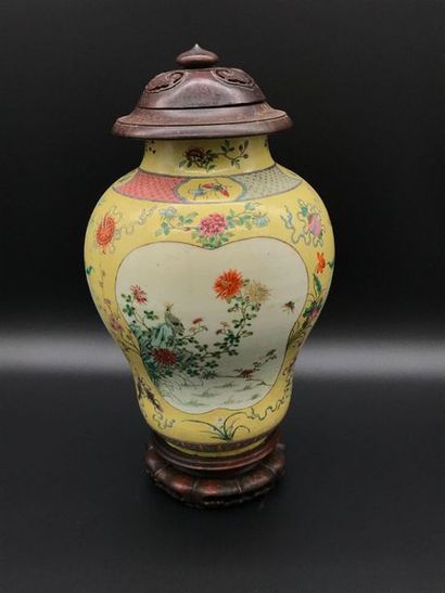 null A covered porcelain jar with a yellow background decorated with chrysanthemums,...