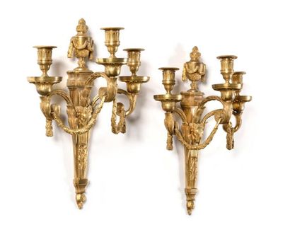 null Pair of three-branched gilt bronze light arms, the barrel with ram's heads surmounted...
