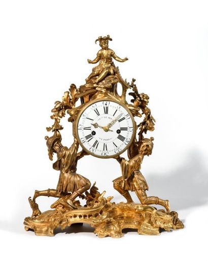 null Chinese clock in gilt bronze, the two Chinese resting on a base decorated with...