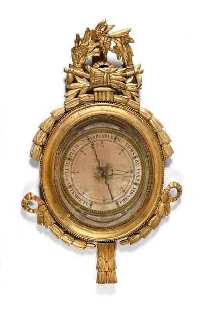 null Carved and gilded wooden barometer of oval shape, decorated with laurel leaves...