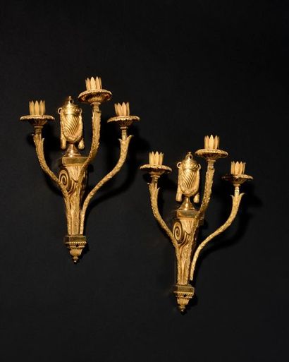 null Pair of three-branched gilt bronze light arms, the scrolled shaft surmounted...