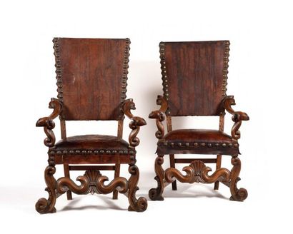 null Pair of large walnut armchairs, with high flat backs, of a very lively shape,...