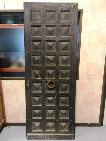 null Carved wooden door with boxes. 

Wrought iron doorknocker with brass handle...