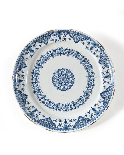 null ROUEN Large circular earthenware dish decorated with blue rosette and mantling....