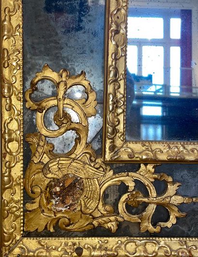 null Moulded and carved gilded wood MIRROR WITH PARECLOSES. The rounded pediment,...