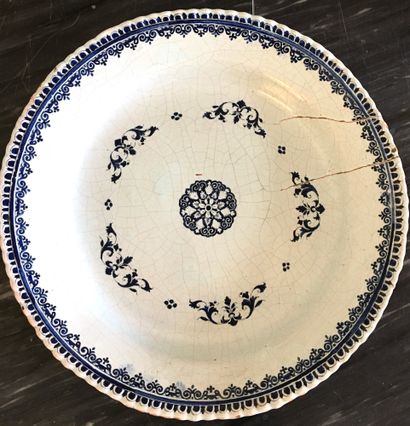null ROUEN Large circular earthenware dish decorated in blue camaieu with a rosette...