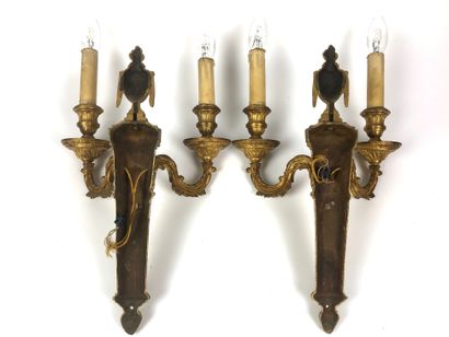 null Pair of ormolu and chiselled bronze sconces with two light arms ending in windings...