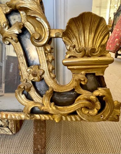 null Moulded and carved gilded wood MIRROR WITH PARECLOSES. The rounded pediment,...