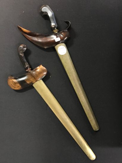 null Two Malaysian KRISS

with corrugated blade, wooden and brass sheath, carved...