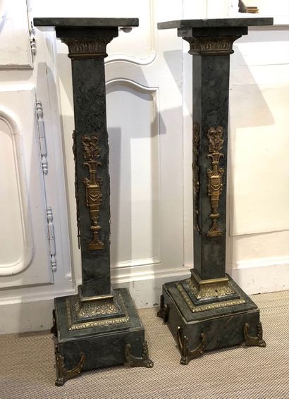 null PAIR OF SELETS in green-grey marble with square shafts and military bronze decoration....