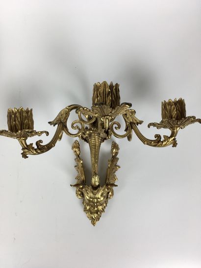 null Pair of ormolu and chased bronze sconces with three moving light arms, joined...