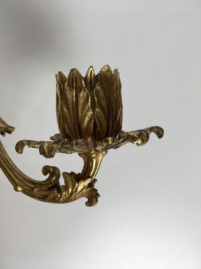 null Pair of ormolu and chased bronze sconces with three moving light arms, joined...