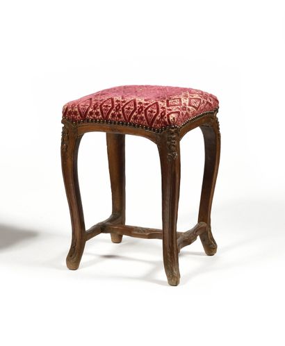 null A square shaped carved beechwood TABOURET, resting on cambered legs joined by...