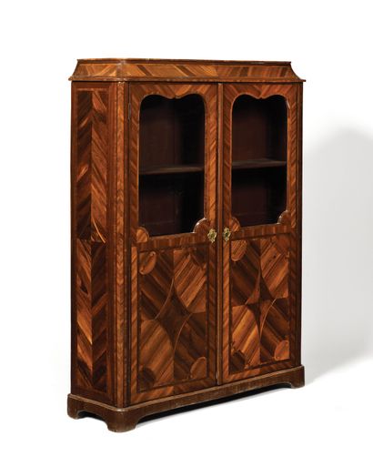 null A rosewood and satinwood bookcase, the sides moved, opening to two glass doors...