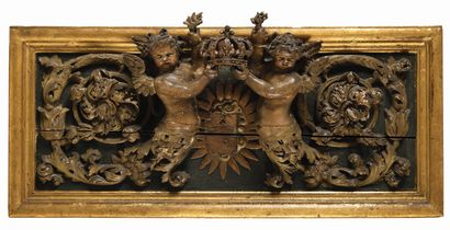 null A painted and gilded carved wood doorframe decorated with two children-arabesque...
