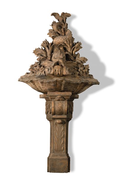 null A terracotta FOUNTAIN composed of a basin representing a shell, topped by a...