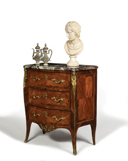 null A violet and rosewood chest of drawers with a butterfly wing veneer, the front...