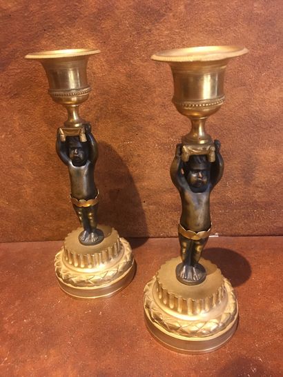 Pair of bronze candlesticks decorated with...