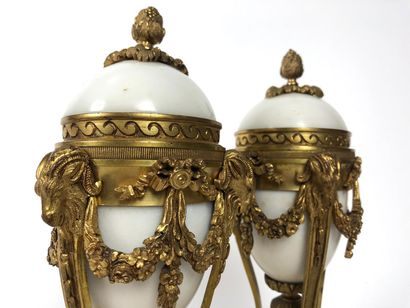 null A Pair of ormolu and white marble candlesticks standing on a tripod base with...