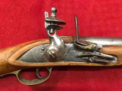 null Flintlock rifle with its walnut stock. Four sabres are attached (used scabb...