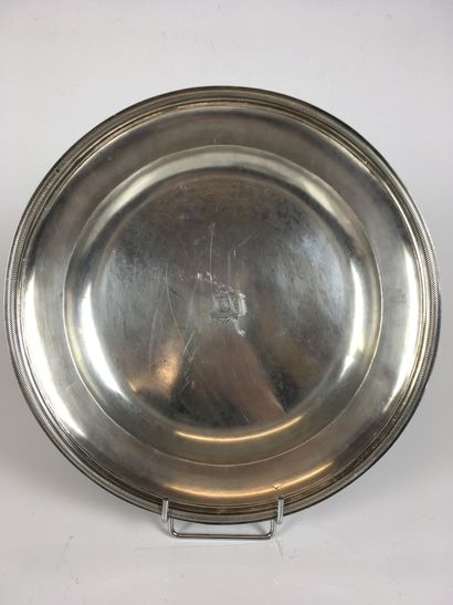 A silver round dish with gadrooned contours,...