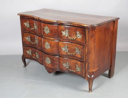 null A moulded and panelled walnut chest of drawers with three rows of drawers, rounded...