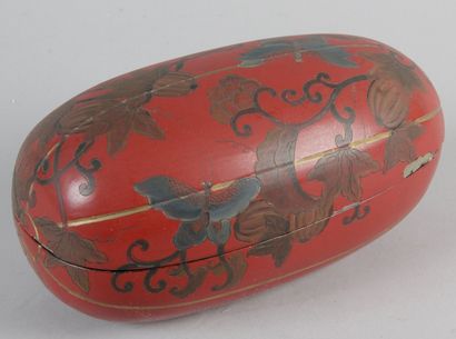 null BOX IN THE FORM OF A CURNOW, in red lacquer and gilded foliage and vase of flowers....