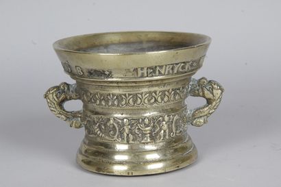 null BRONZE MUG carved with cherubs and dolphin handles with an inscription " HENRYCK...