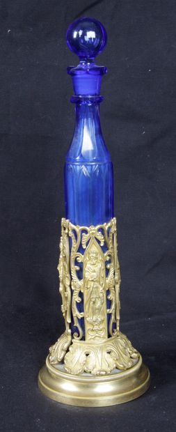 null A MELISSIAN WATER BOTTLE, in blue glass with its stopper and its gilt bronze...