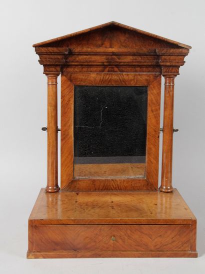 null A mahogany and mahogany veneer table top with columns and a pediment. And resting...
